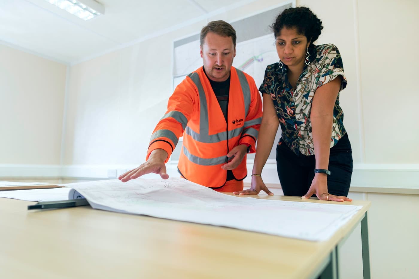 Engineers reviewing technical drawings at a project site
